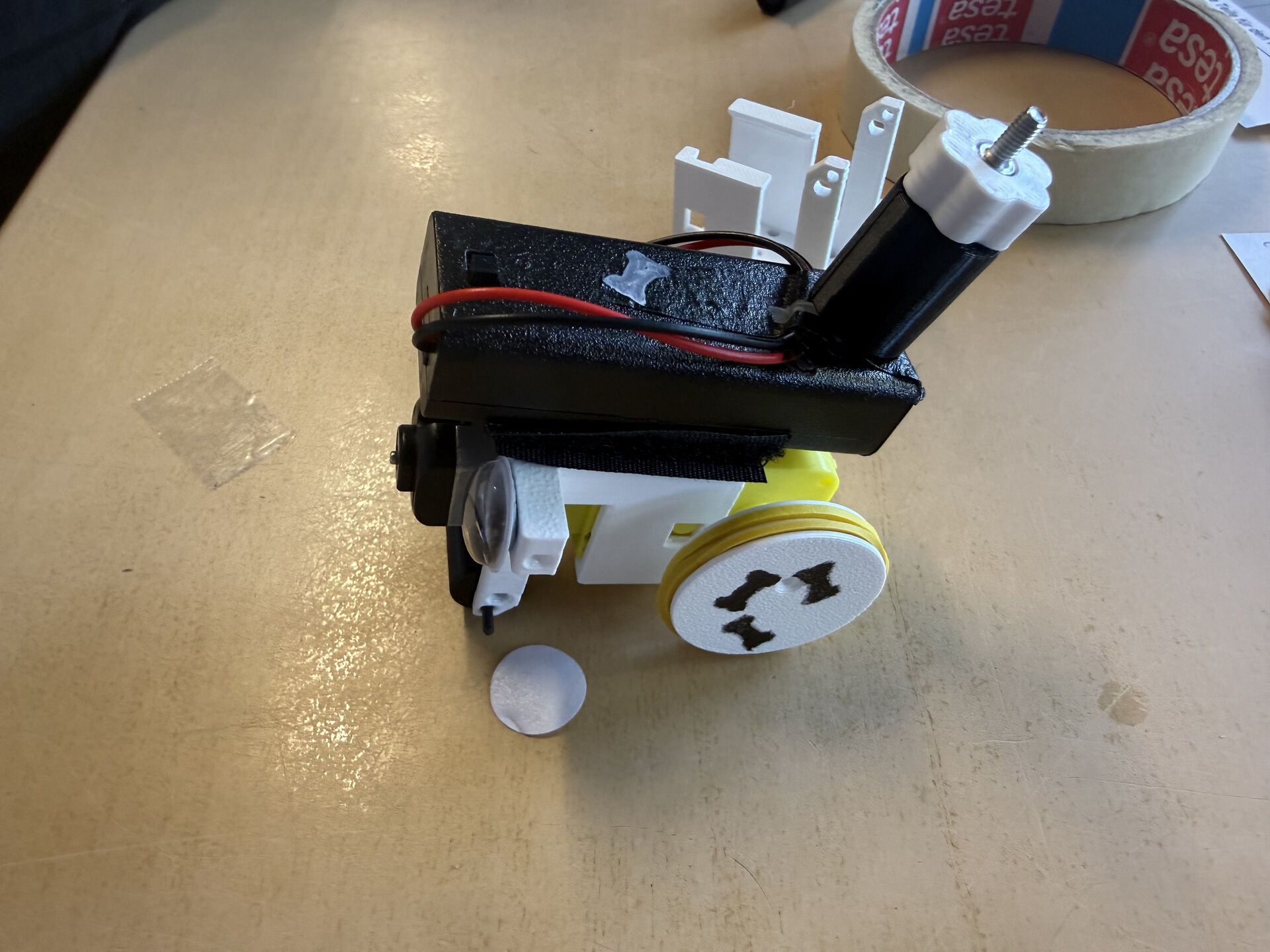 Close-up of a finished robot with battery pack, wheels and a printed frame