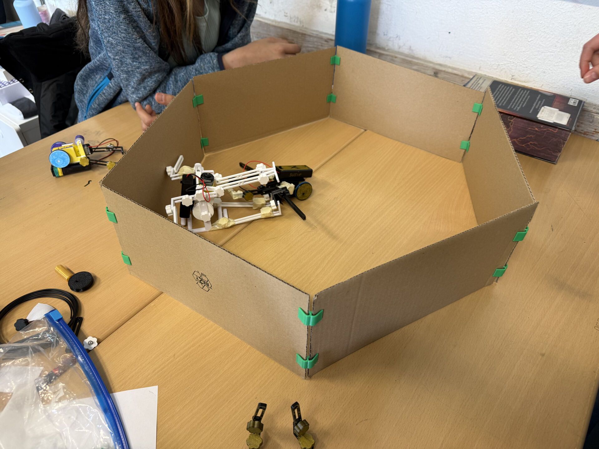 Cardboard hexagonal arena with two robots inside