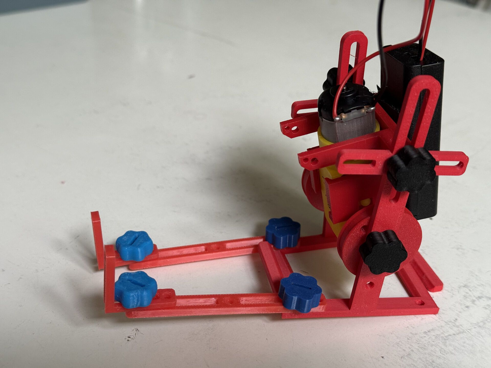 Red 3D-printed kicker robot with detachable front frame