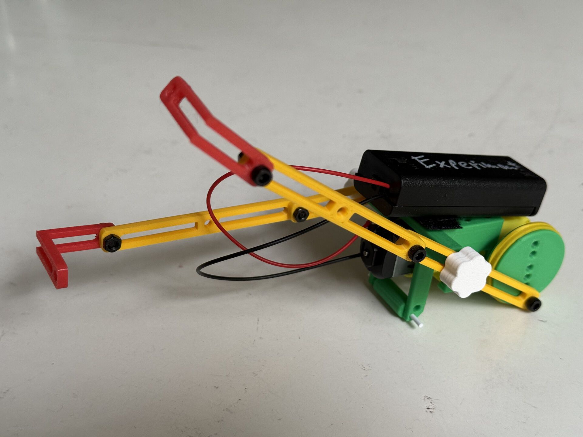 Yellow and green boxer robot with extended arm