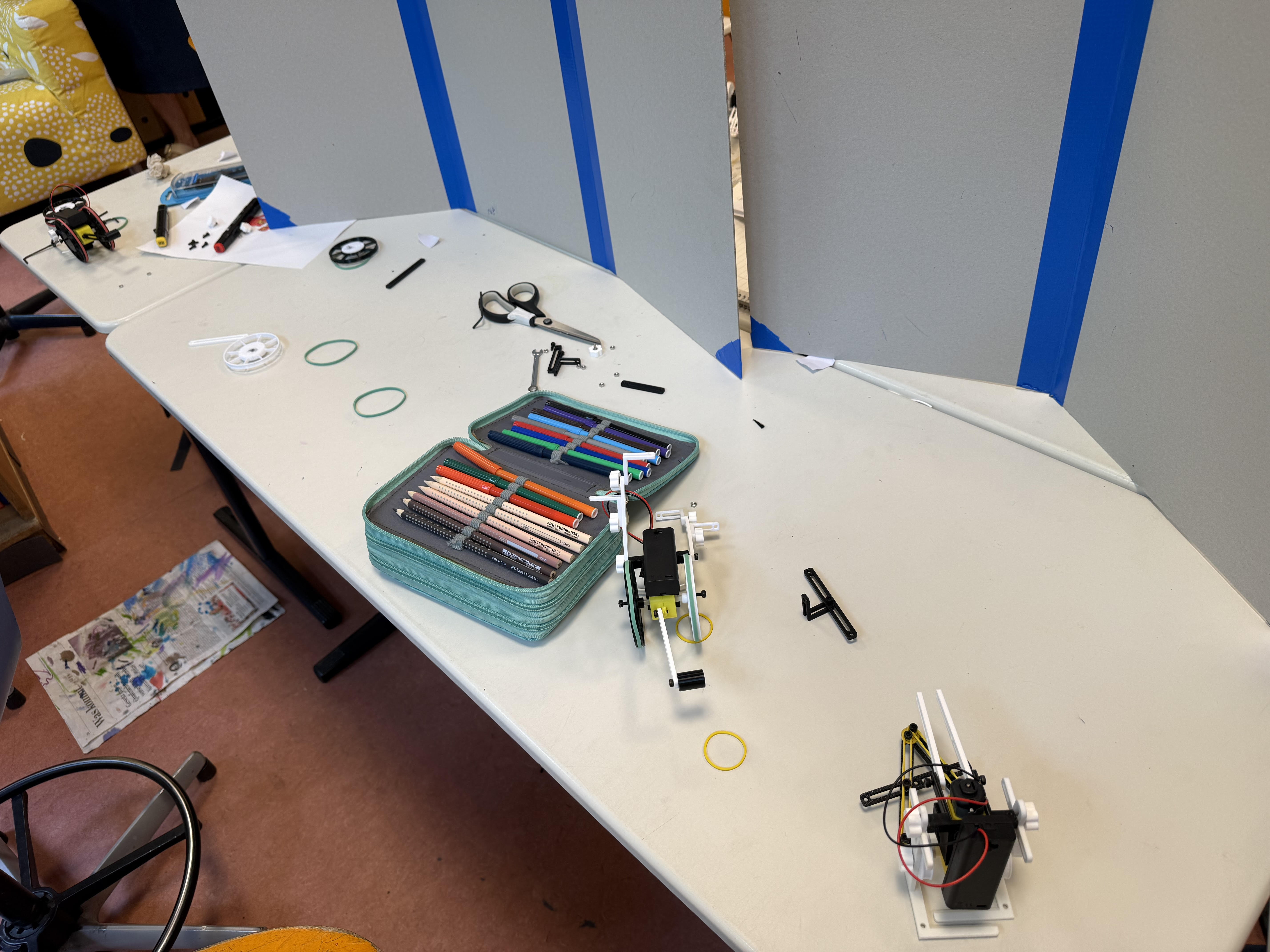 Table lined with parts boxes, batteries and printed build manuals